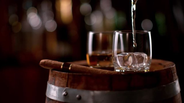 Super slow motion of pouring whiskey into glass. Filmed on high speed cinema camera, 1000fps