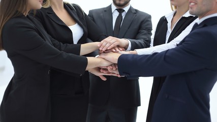 close up.a group of business people put their hands together