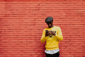 Portrait of handsome afro man using his mobile.