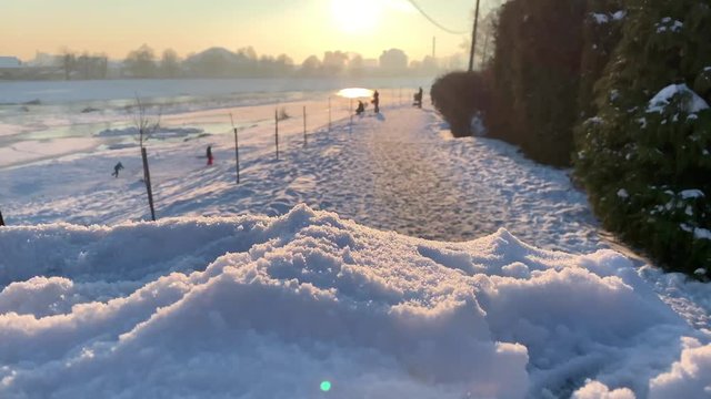 Snow slide. Close up view os snow. Nature. Sunset time. Frozen river in background