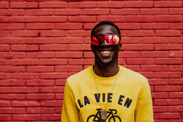 Portrait of handsome afro man using his mobile.