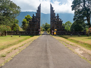 Traditional Hindu gates and statue at summer day - Candi Bentar, Bedugul in Bali, Indonesia. October, 2018