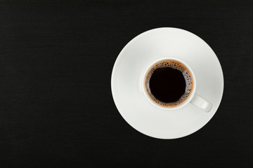 Full white espresso coffee cup over black