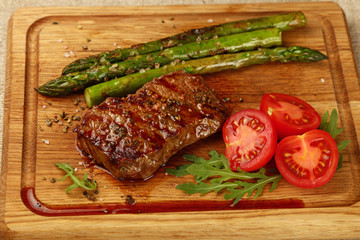 Close up grilled beef steak on wooden board