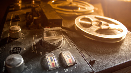 Vintage tape recorder is playing music, soft light