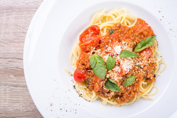 spaghetti bolognese with veal and basil leaves