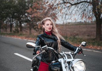 Plakat Beautiful woman with motorcycle outdoors.
