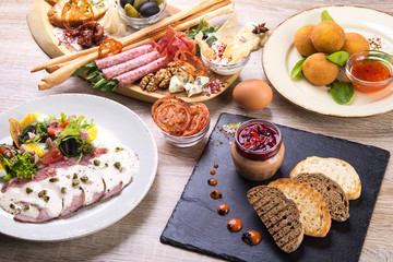 set of dishes with salad, arancini, shack board