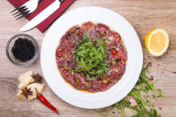 beef carpaccio with arugula and black caviar