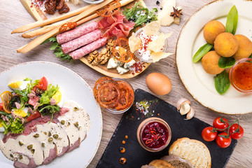 set of dishes with salad, arancini, shack board