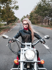 Fototapeta na wymiar Beautiful woman with motorcycle outdoors.