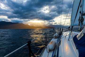 view from the yacht on the evening sunset over the sea and mountains