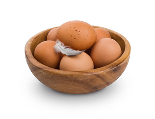 Several brown Eggs in wooden bowl isolated on white background