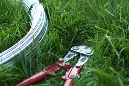 Bolt cutter near the coil wire on the grass
