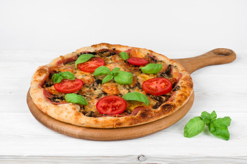 Tasty fast food traditional Pizza on wooden kitchen table