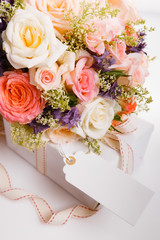 Luxury bouquet made of red roses in flower shop and white ribbon on wooden board. Overhead top view, flat lay. Copy space. Birthday, Mother's, Valentines, Women's, Wedding Day concept