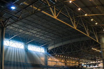 Interior of warehouse. large metal structures, ceiling. roof. concept production and installation of equipment for rooms, lighting, ventilation and windows for hangars