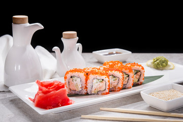 Tasty japan sushi with red ginger, soy sauce and sesame