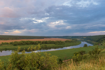 Fototapeta na wymiar sunset over fields and river