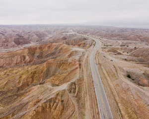 Aerial view of empty road passing through desert