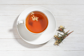 Cup of tea with rosemary. Dried medicinal herbs, branches with leaves and flowers. Ledum Palustre, Rhododendron tomentosum (wild rosemary, marsh Labrador tea).