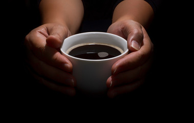 Hand holding a cup of coffee