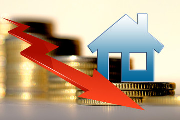Real estate symbol and arrow on a background of money . The concept of financial instability in the...