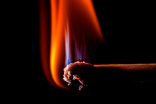 Close up of burning matchstick