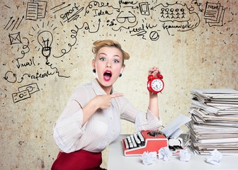 Fototapeta premium Attractive young woman working on vintage typewriter on