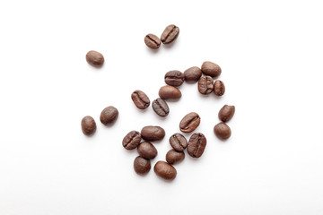 Roasted coffee beans isolated on white background. Close-up.