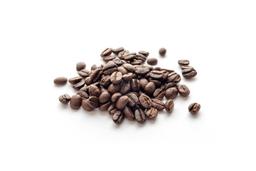 Roasted coffee beans isolated on white background. Close-up.