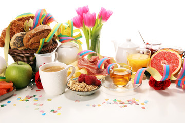 breakfast on table with bread buns, croissants, coffe and juice on carnival