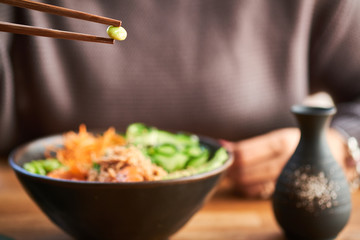 Woman eating poke bowl