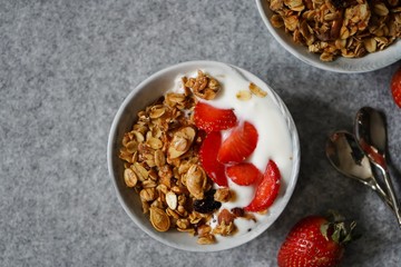 Homemade Granola Yogurt bowl with fresh strawberries