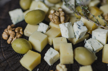 Cheese set with olives  on black wooden board