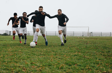 Group of men playing soccer on the field © Jacob Lund