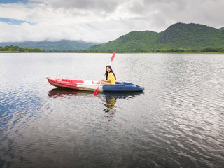 Woman kayaking on lake