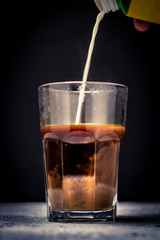 pouring coffee or milk tea into cup or glass. / splash coffee or milk tea