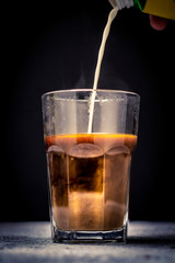 pouring coffee or milk tea into cup or glass. / splash coffee or milk tea