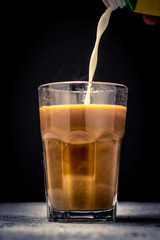 pouring coffee or milk tea into cup or glass. / splash coffee or milk tea