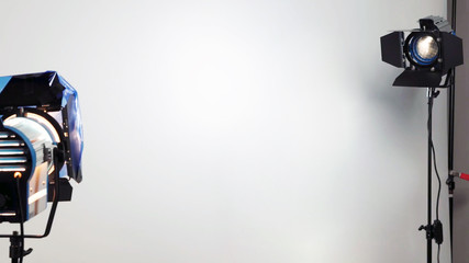 Empty photo shooting studio between two standing spotlights realistic for interview or photography session. copy space in the middle background.