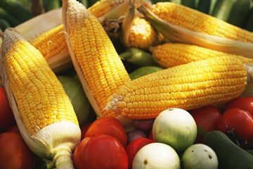 Tropical fruit and vegetable display, sweet corn, tomato, eggplant, green food concept
