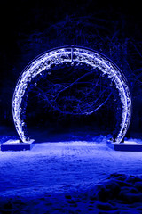 Part of New Year sign 2019, number 0, framed with decorated street lamps, street garlands.