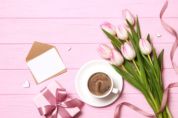 bouquet of beautiful tulips, gift and coffee on wooden background top view. Mother's Day Background, International Women's Day, Birthday. Holiday, give a gift.