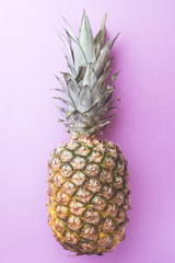 Ripe pineapple on a pink toned background. Copy space