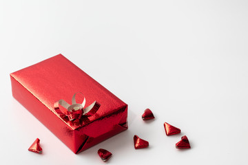 Red gift box for Valentine's Day or various festivals and red hearts that folded from paper Arrange the elements in the lower left corner.