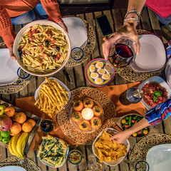 Party with friends, dinner on the terrace in joy, aperitif at the end of summer, dinner with beer and pretzels, happiness and festivities. Square image