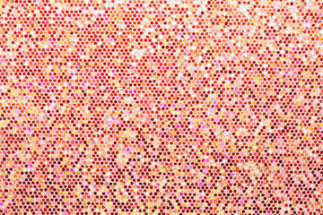 Red orange background. Abstraction shiny sequins. Sequins texture closeup macro