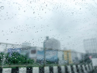 the rain on mirror car with constuction site background.