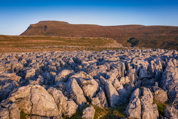 Fototapeta na wymiar Ingleborough (723 m or 2,372 ft) is the second-highest mountain in the Yorkshire Dales.[1] It is one of the Yorkshire Three Peaks (the other two being Whernside and Pen-y-ghent), and is frequently cli